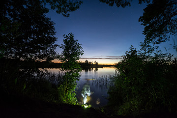 Obraz premium Fisherman in water at night. Night underwater fishing