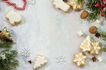 Christmas background frame or greeting xmas card. Gingerbread on a festive Christmas table. Flat lay, top view with copy space.