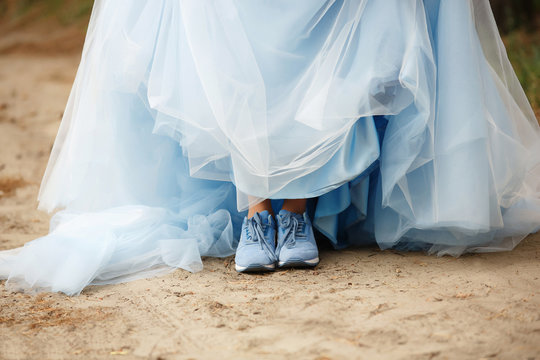 Blue women dress and blue sport shoes. Creative bride at wedding day