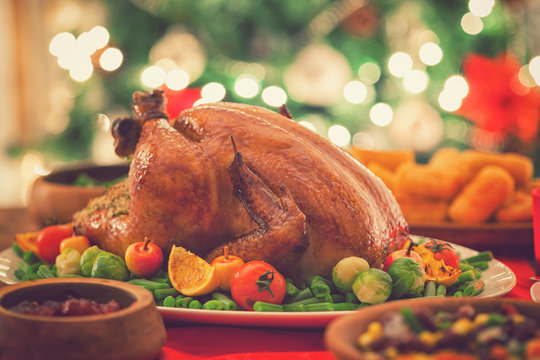 Stuffed Christmas Turkey Dinner Served In Front Of A Christmas Tree 