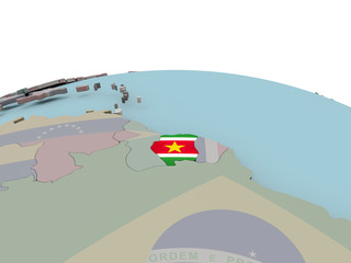 Naklejka premium Political map of Suriname on globe with flag