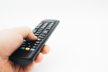 Television remote control in the hand on white background