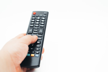 Television remote control in the hand on white background