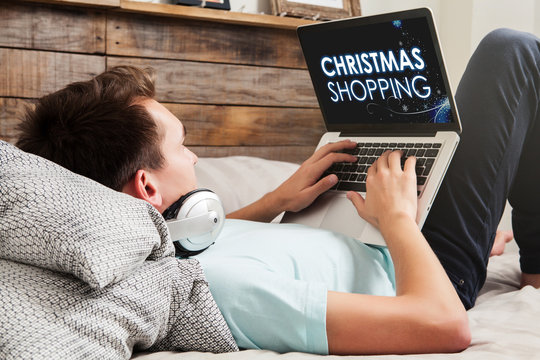 Man using a laptop for Christmas Shopping by internet.