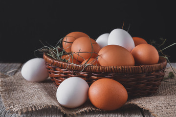 Fresh chicken white and brown eggs on sack closeup, organic farm