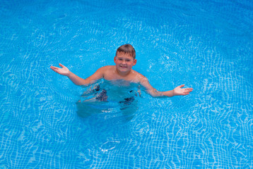 Activities on the pool. Boy swimming and playing in water. Happiness and summertime