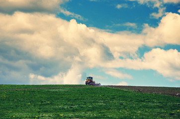 Agriculture tractor cultivating field.Springtime.Arable land.Ploughing.