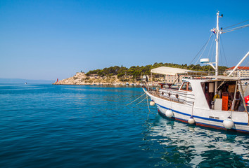 Naklejka na ściany i meble Motor boats parked at pier in Makarska city. Popular tourist destination. Croatia