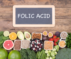 Folic acid food sources, top view on wooden background 