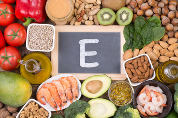 Vitamine E food sources, top view on wooden background 