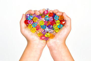 children's hands, hands holding beads on a white background