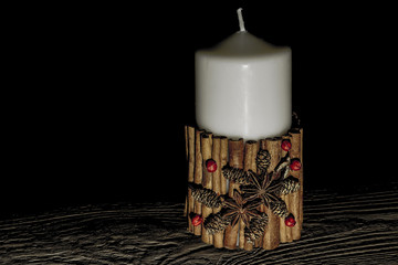 Christmas candle with decoraton isolated on black