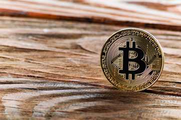 Coin bitcoin on a wooden background