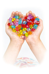 children's hands, hands holding beads on a white background