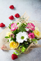 Valentine's day background or greeting card. A beautiful bouquet of flowers as a gift on a gray slate or stone background.