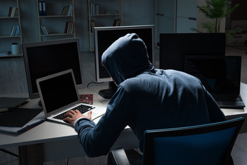 Hacker hacking computer at night