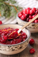 Homemade Cranberry Sauce served in a bowl on festive background