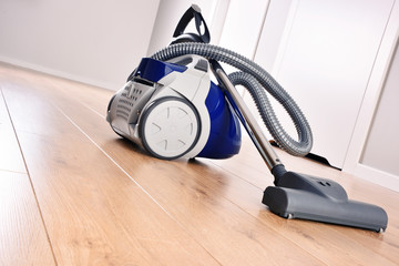 Canister vacuum cleaner for home use on the floor panels