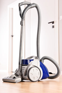 Canister vacuum cleaner for home use on the floor panels