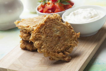 Hash browns, fried potato pancake served on wooden board