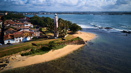 Fototapeta na wymiar aerial shot of old lighthouse in tropical colonial fort