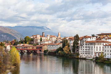 Fototapeta na wymiar Bassano del Grappa with river Brenta and bridge Ponte Alpini