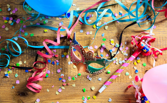 Carnival Party. Mask, Confetti And Serpentines On Wooden Floor