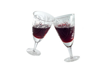 clinking vintage faceted crystal glasses (no hands) with red wine isolated