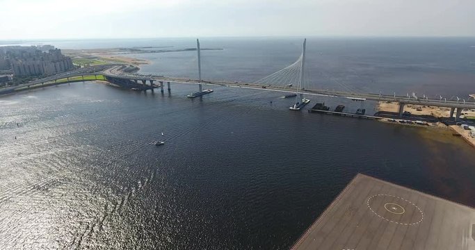 Flight to cable-stayed suspension bridge over Petrovsky fairway in Gulf of Finland. WHSD viaduct above sea. St. Petersburg, Russia