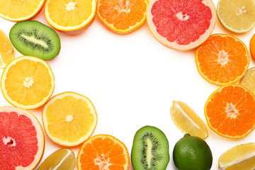 healthy food. mix sliced lemon, green lime, orange, mandarin, kiwi fruit and grapefruit with green leaf isolated on white background. top view with copy space
