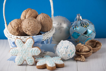 Fototapeta na wymiar Gingerbread in the form of a snowflakes near the basket with walnuts