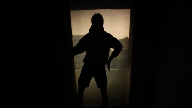 Silhouette of a young man dancer dancing funky hip hop r b on isolated studio. Footage. Silhouette of a dancing young man