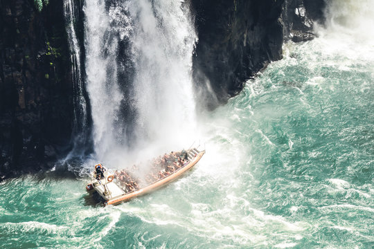 Boat under a waterfall