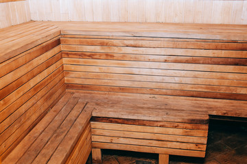 Finnish wooden modern sauna interior. Empty sauna with nobody in. Wooden sauna room. Interior of sauna steam wooden room.