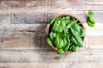 Fresh baby spinach in a wooden bowl