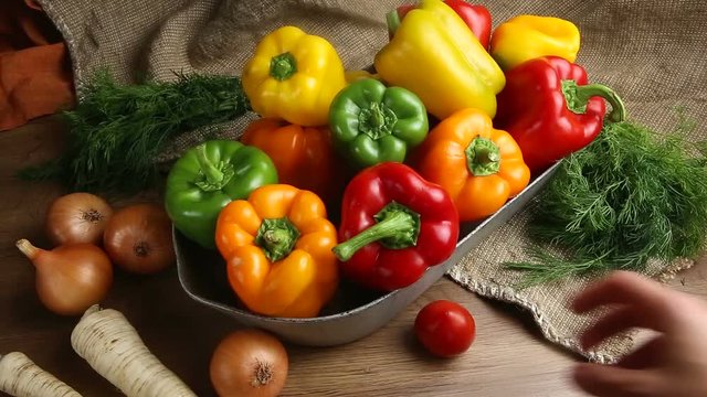 Red, green and yellow sweet bell peppers on table,