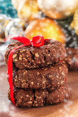 Healthy chocolate nuts oats cookies on wooden background. Christmas style photo. Selective focus. Vertical.