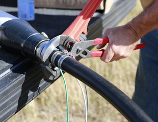 Close up of plumbers  hands mounting new submersible water pump