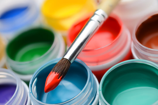 Gouache paint jars and paintbrush