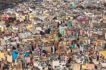 Aerial view on chaos of colored buildings - the heap of houses in the Asian cities caused by big human overpopulation.