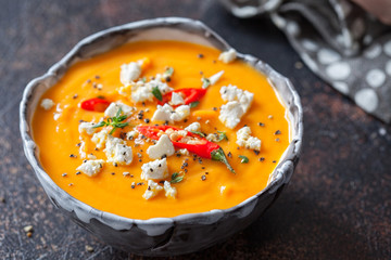 Roasted pumpkin and carrot soup with feta cheese and chili