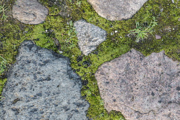 Fragment of the old road paved granite stones