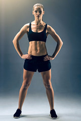 Fototapeta na wymiar Strong body and mental health. Full length shot of a female athlete in a two piece sportswear standing on the feet more than shoulder width apart and looking into the camera confidently.