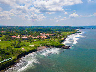 Beautiful aerial view of the sea landscape and golf field near Tanah lot temple, Bali island, Indonesia.