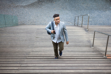 Inquisitive intern moving up stairs outdoors 