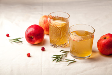 Two vintage glasses with apple cider on black background. Christmas beverages concept. Two red...