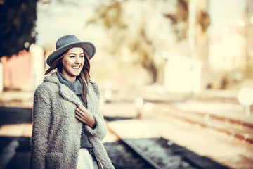 Young woman with hat on train station