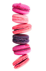 Pink macaroons cookies falling row isolated on white background