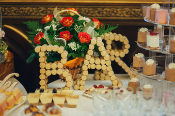 Wedding reception dessert table with delicious decorated white cupcakes with frosting