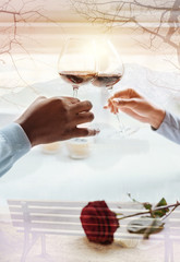 Happy future. Close up of clanging glasses with wine in hands of young pleasant couple with romantic atmosphere